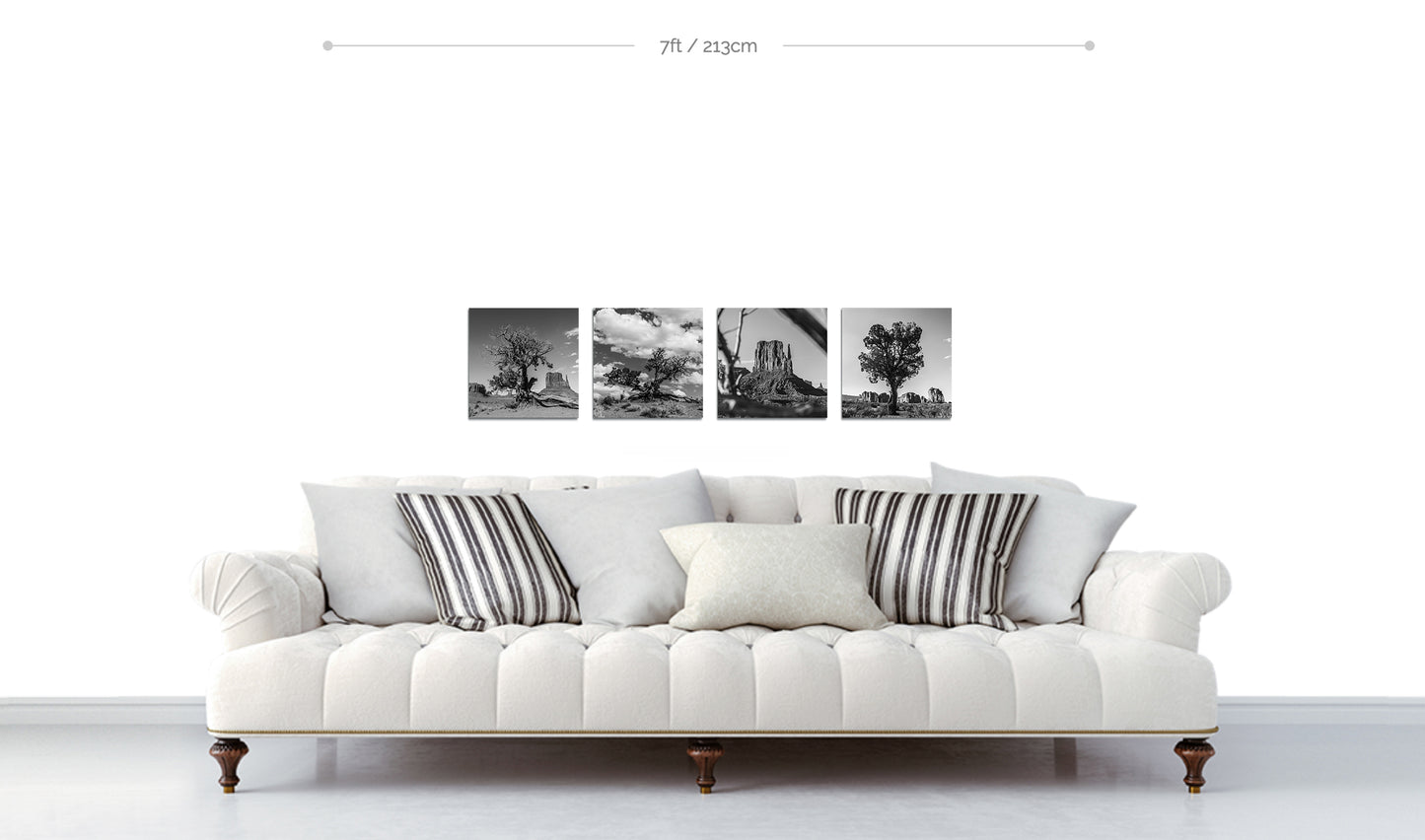 Monument Valley Black and White Fine Art Photographic Metal Prints arranged in horizontal line on wall above white sofa with patterned pillows