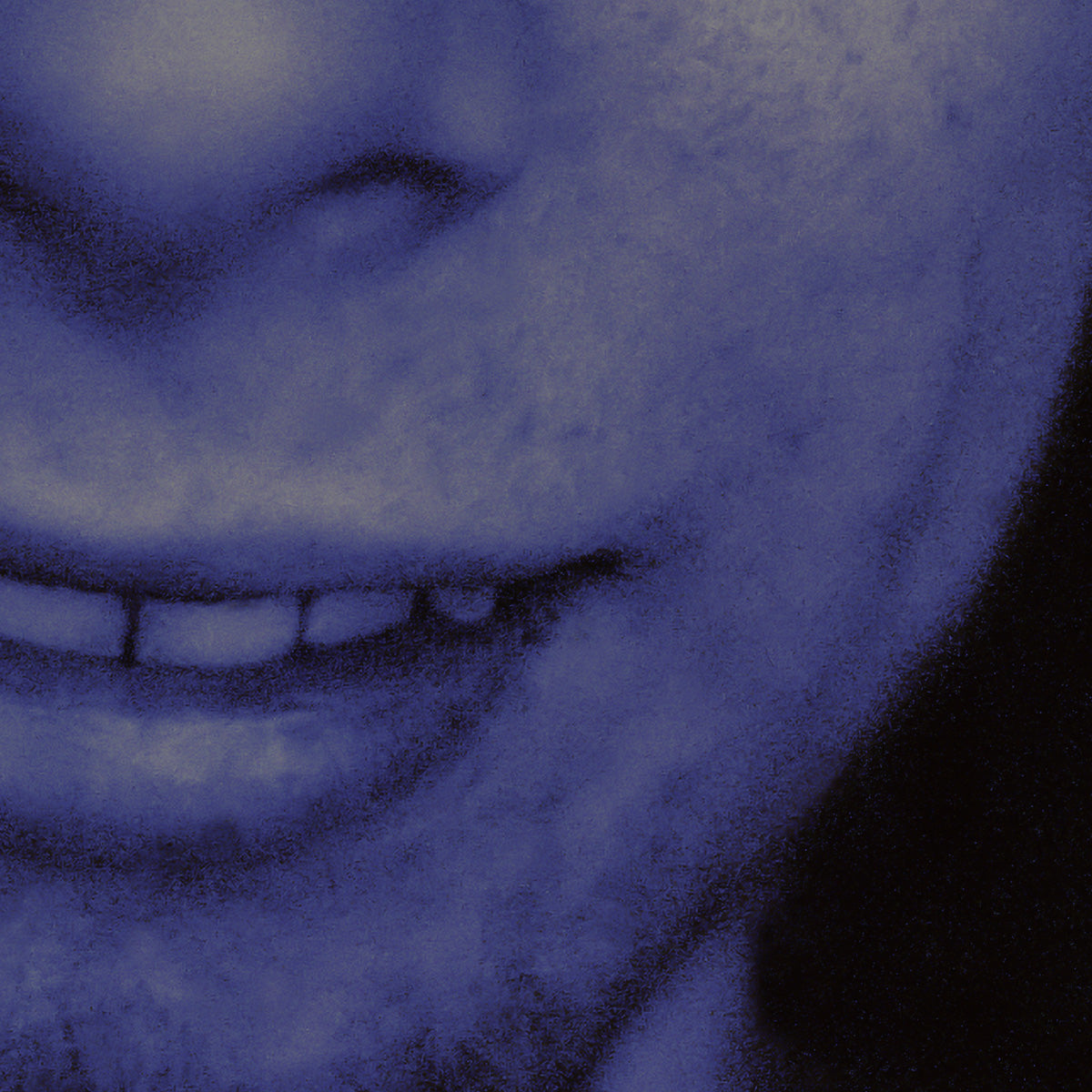 Close-up of a textured blue face with a blurred background