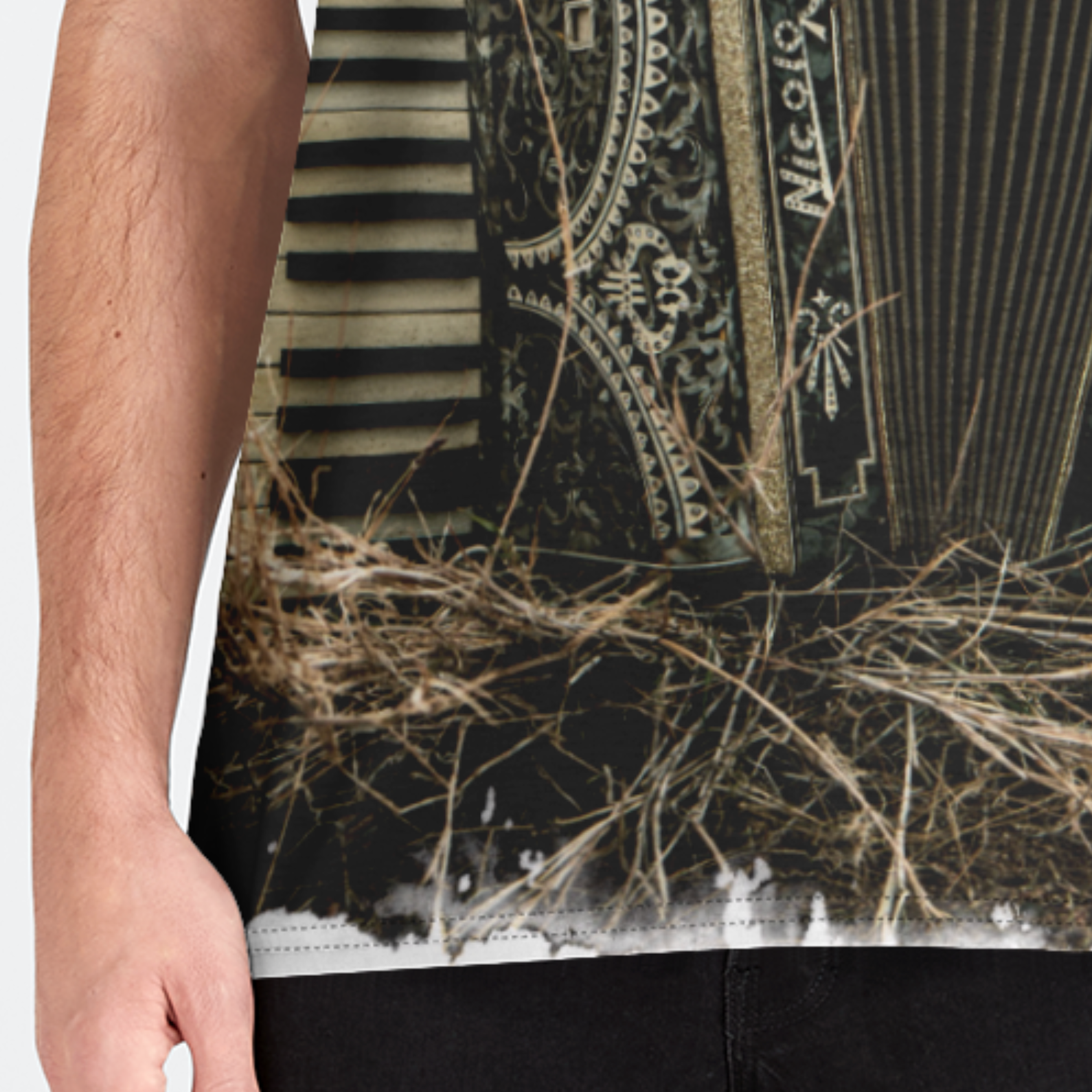 Person wearing a black apron with a detailed design, possibly of a musical instrument and nature elements.