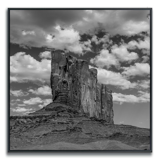 Monument Valley large rock ridge formation under a cloudy sky square print in black and white