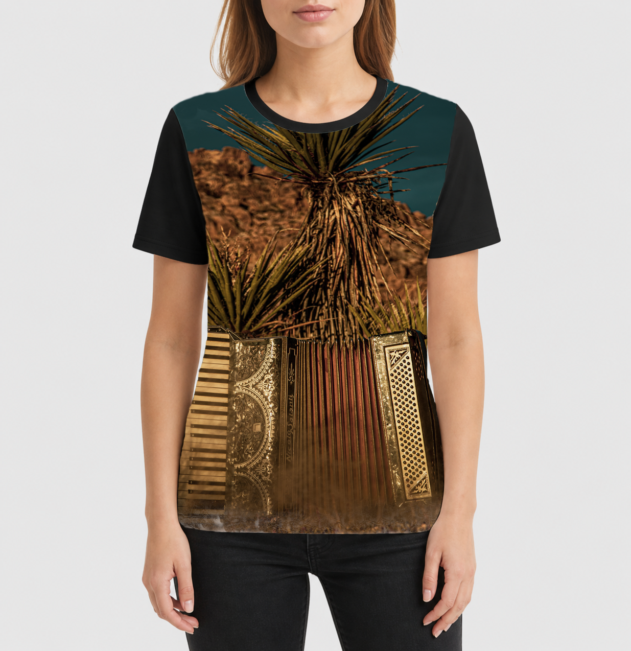 Person wearing a t-shirt with a desert-themed design featuring cacti and architectural elements.