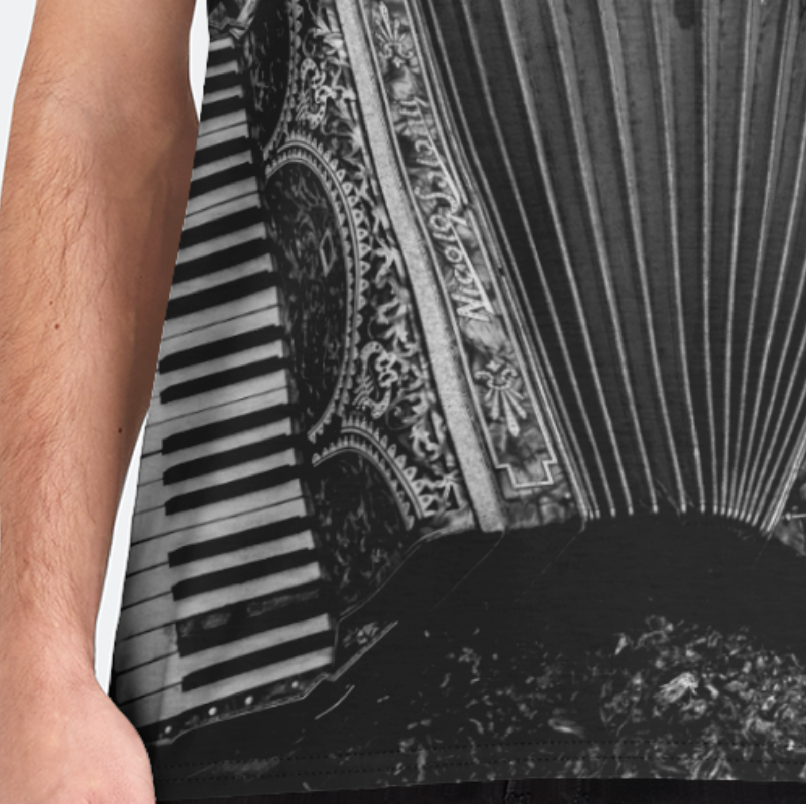Person wearing a sleeveless shirt with a decorative pattern and keyboard design.
