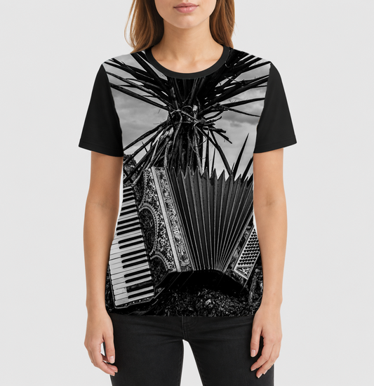 Person wearing a black t-shirt with a black and white graphic design of an accordion and piano keys.