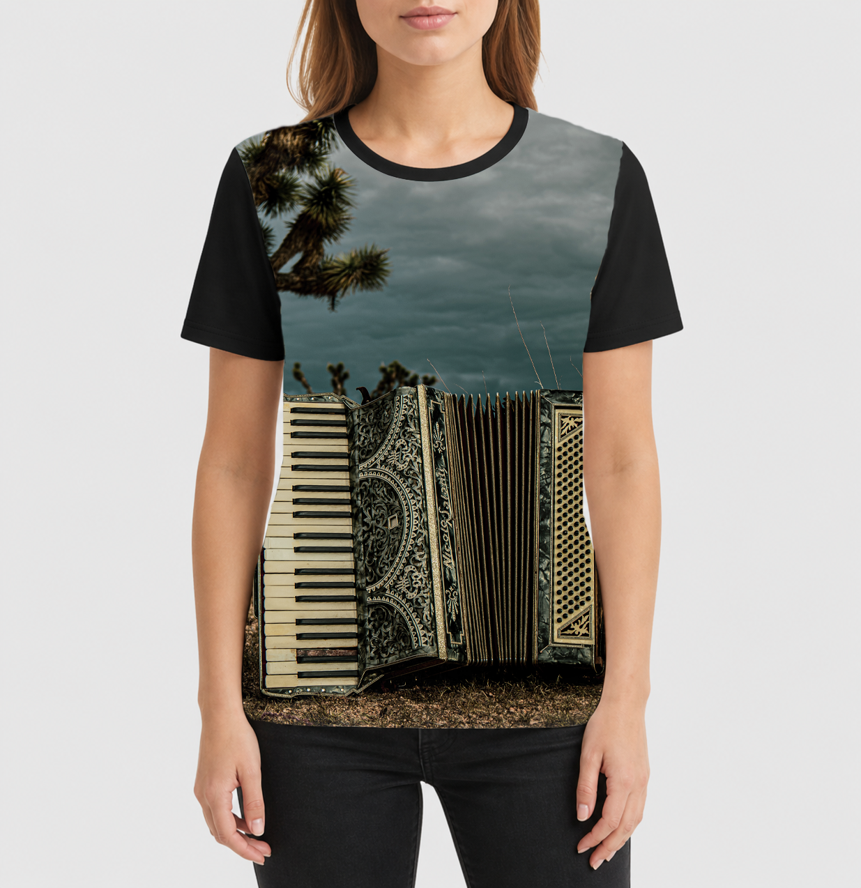 Person wearing a t-shirt with a keyboard and accordion design on a white background