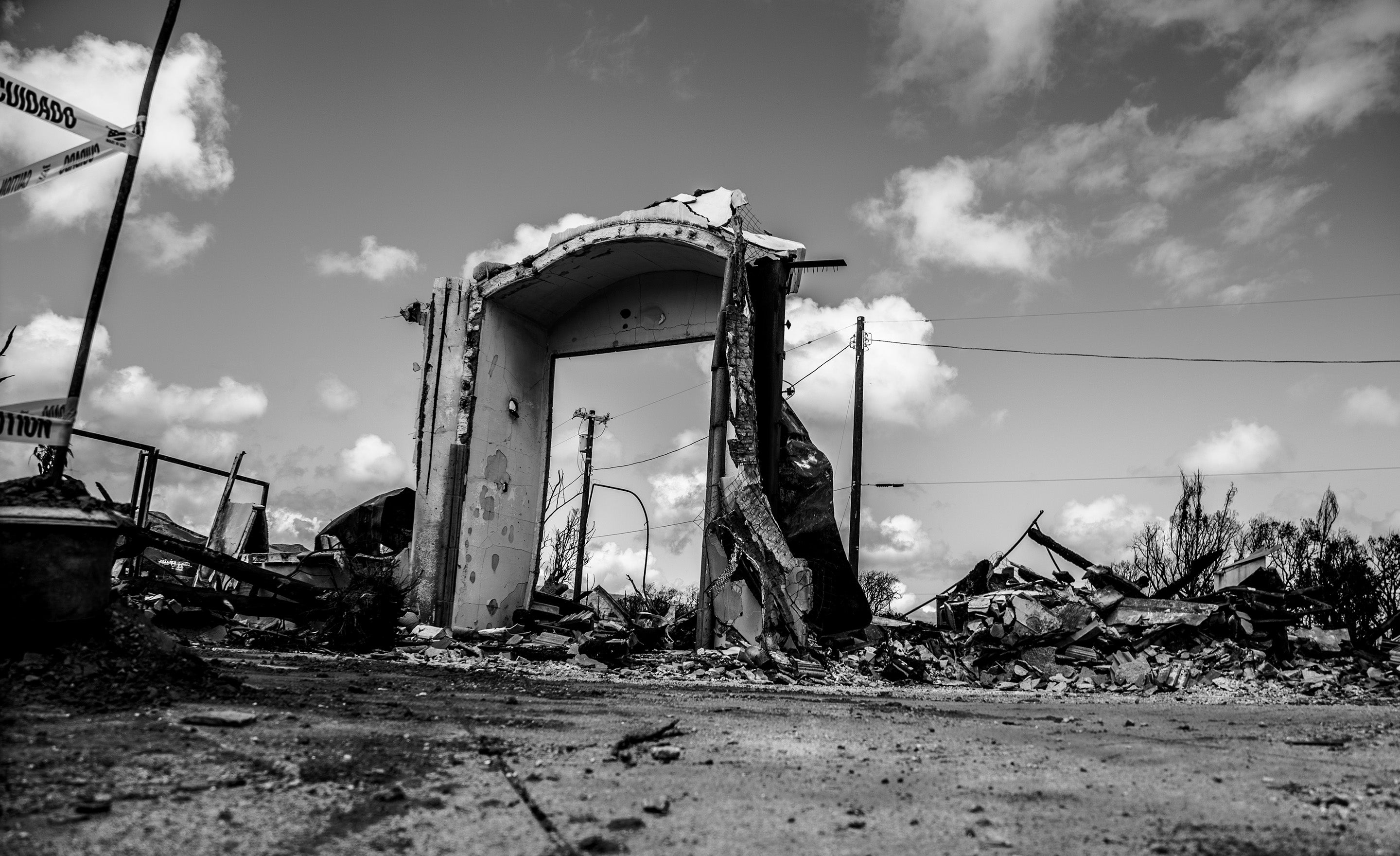 Black and white fine art photograph burnt door frame with clouds behind