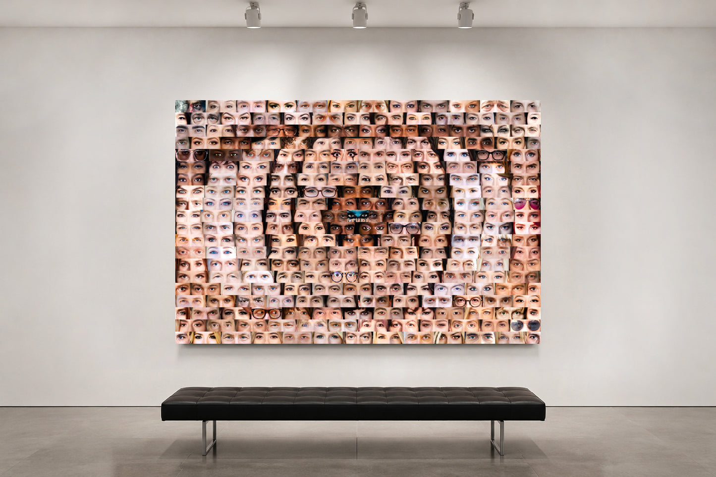 Artistic wall installation of a tiger's face made from smaller images on a white wall with a bench below.