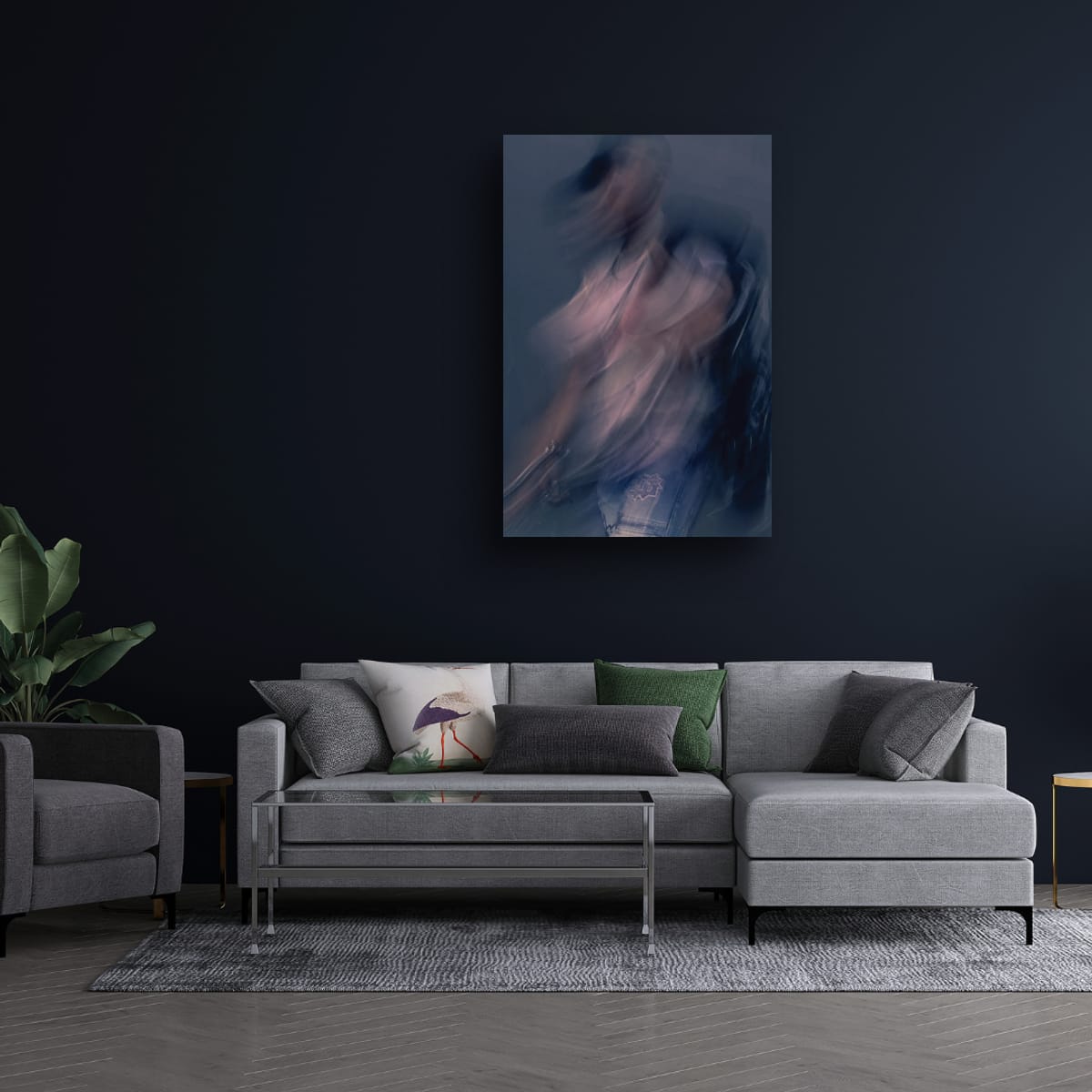 Modern living room with a gray sectional sofa, armchair, and abstract painting on a dark wall.