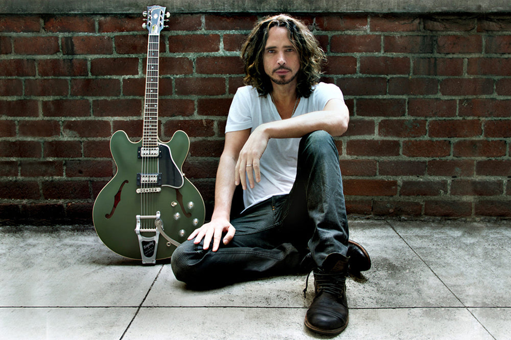 Chris Cornell Branding portrait sitting against brick wall green Signature ES 335 Gibson Guitar leaning against wall beside him