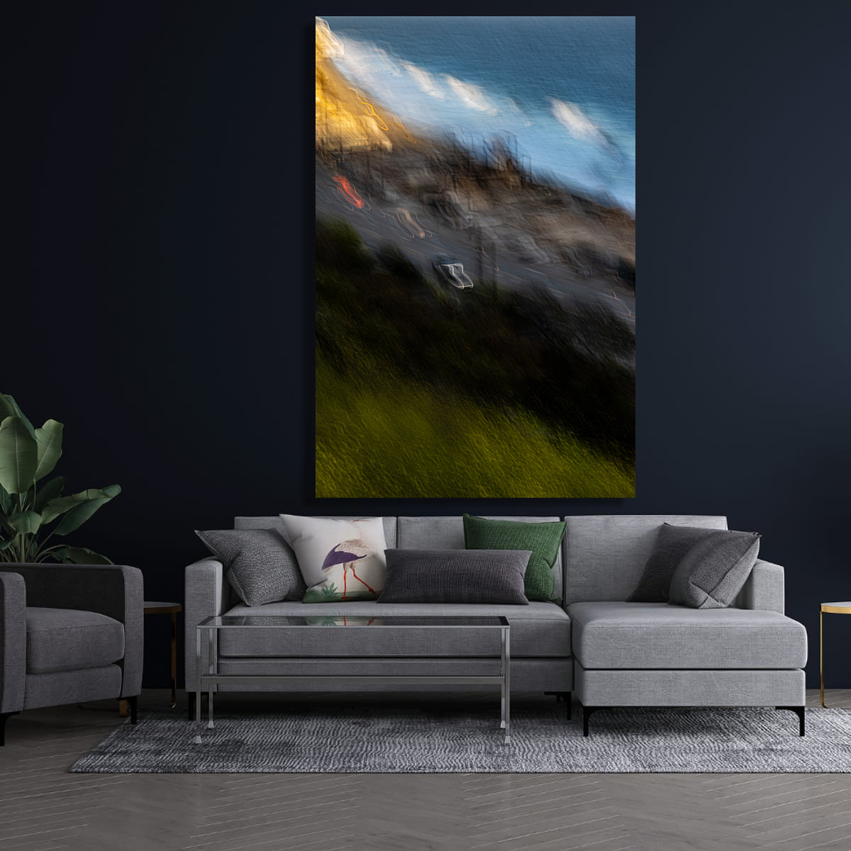 Living room with a gray sectional sofa, armchair, and abstract painting on the wall.