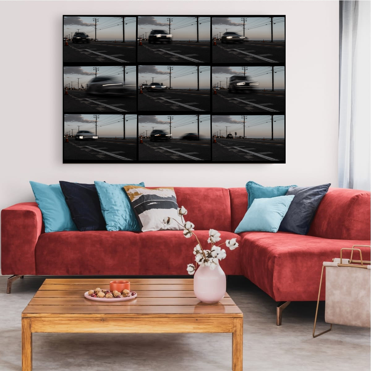 Living room with a red sofa, wooden coffee table, and a large wall-mounted TV displaying a parking lot.