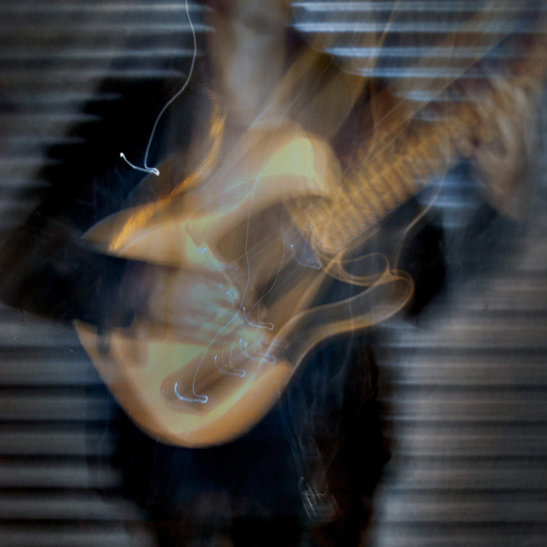 Abstract image of a guitar with smoke or steam effect on a dark background