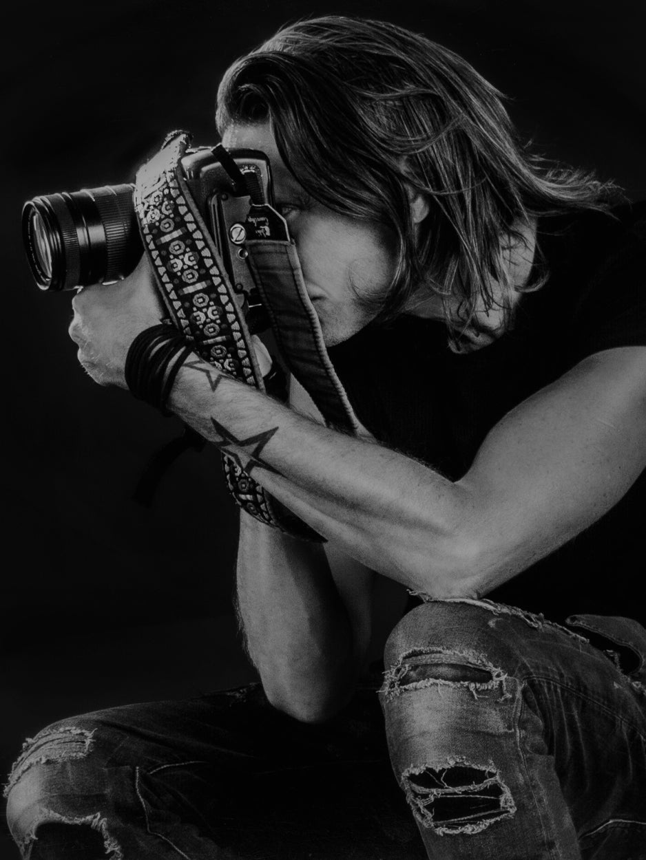 Los Angeles photographer Mark Maryanovich black and white self portrait sitting looking through back of camera