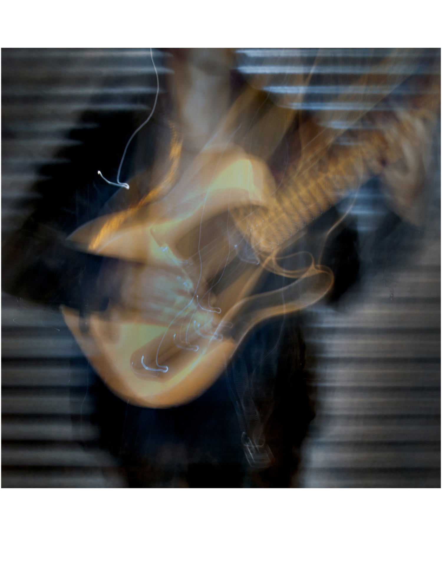 Blurred image of a guitar with a dark background