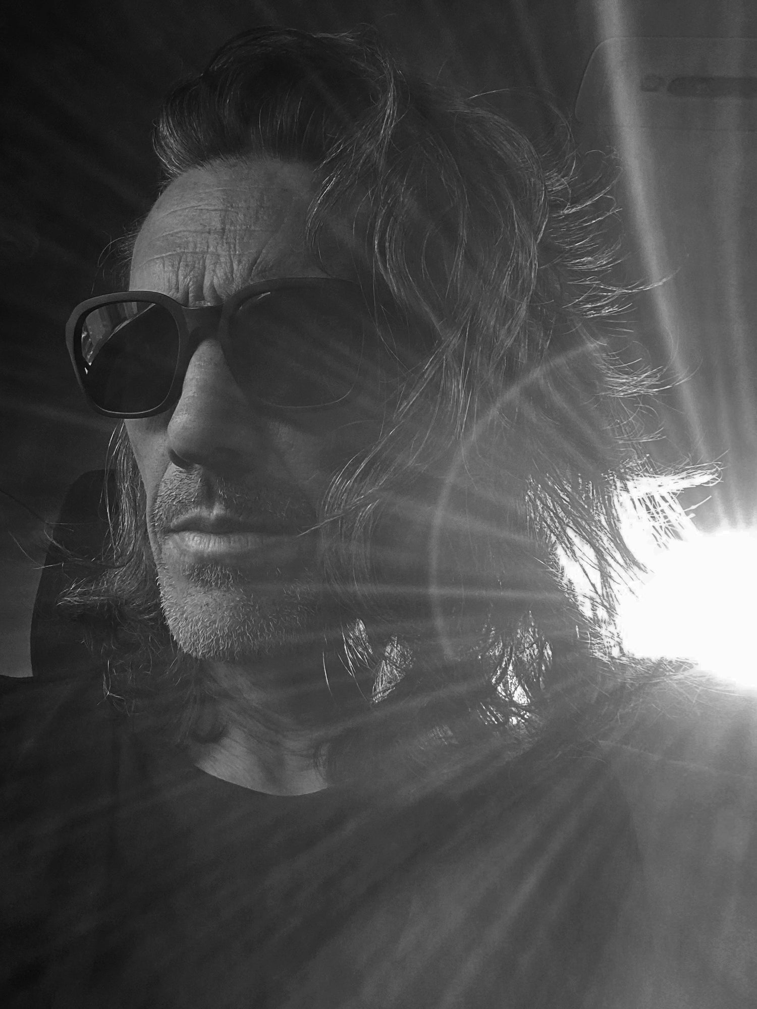 Los Angeles photographer Mark Maryanovich black and white self portrait sitting in back of car