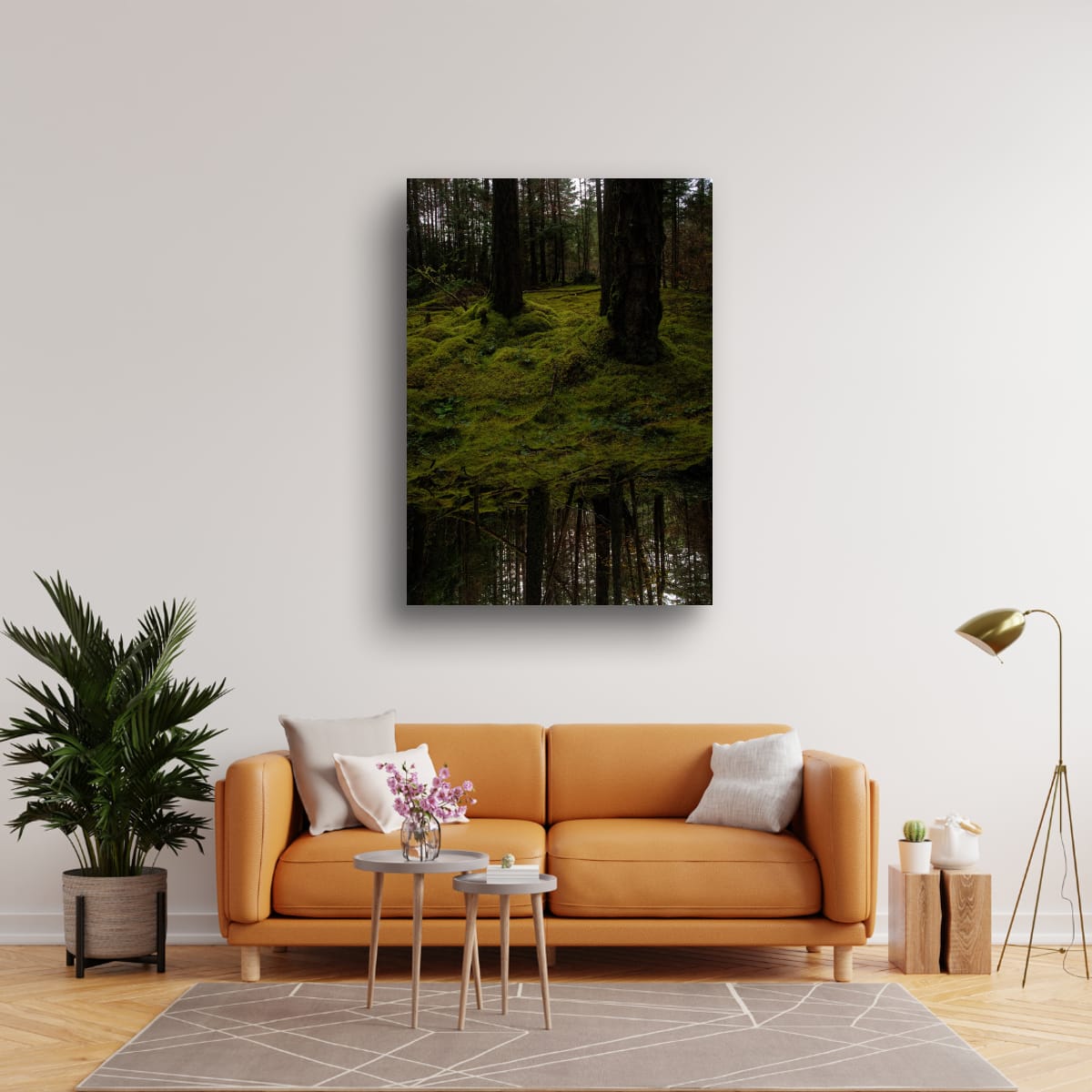 Living room with a brown sofa, plant, and wall art of a forest scene.
