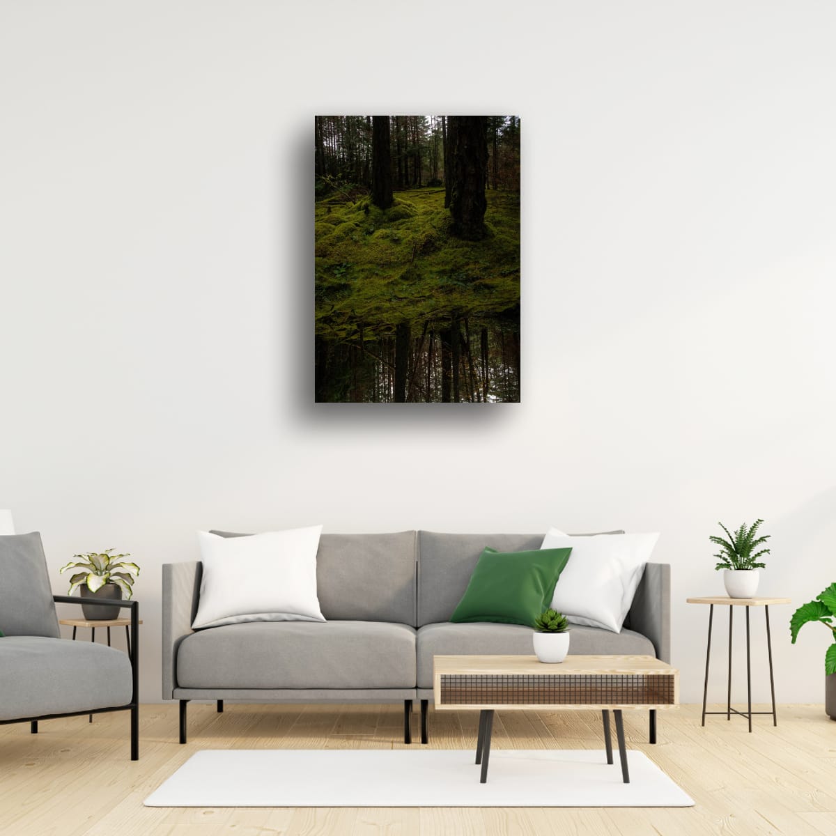 Living room with a gray sofa, coffee table, and wall art of a forest.