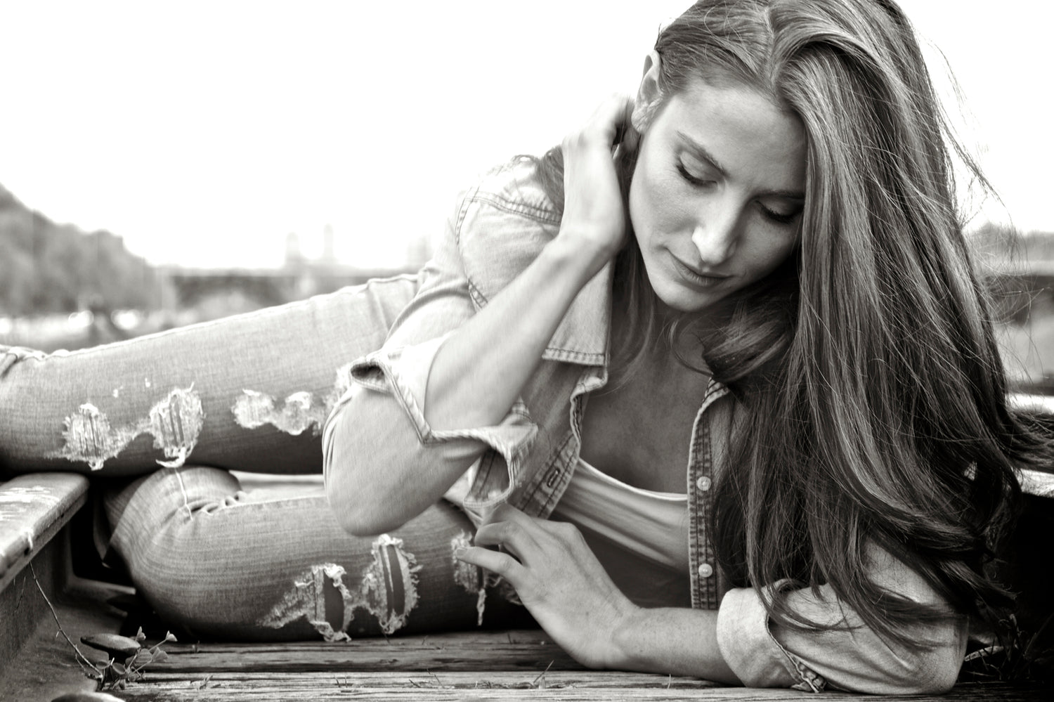 Country music black and white photo Kelsi Mayne wearing denim blue shirt arm up against head