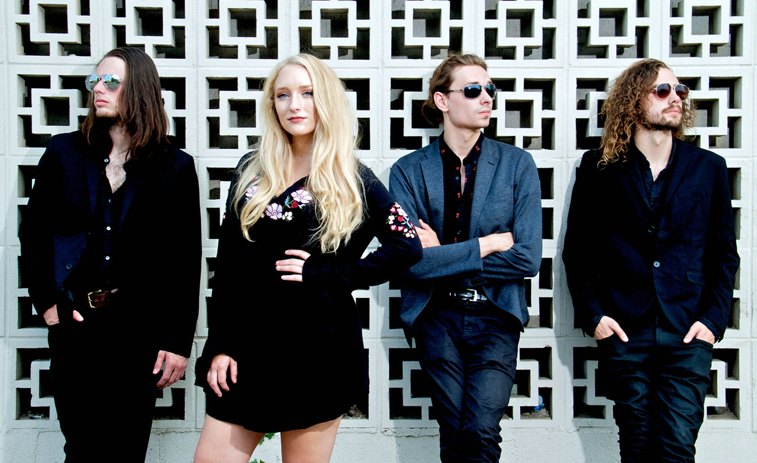 Nashville Country Music Group Portrait Juliana Hale And BAnd Of Roses standing in front of wall of patterned concrete blocks