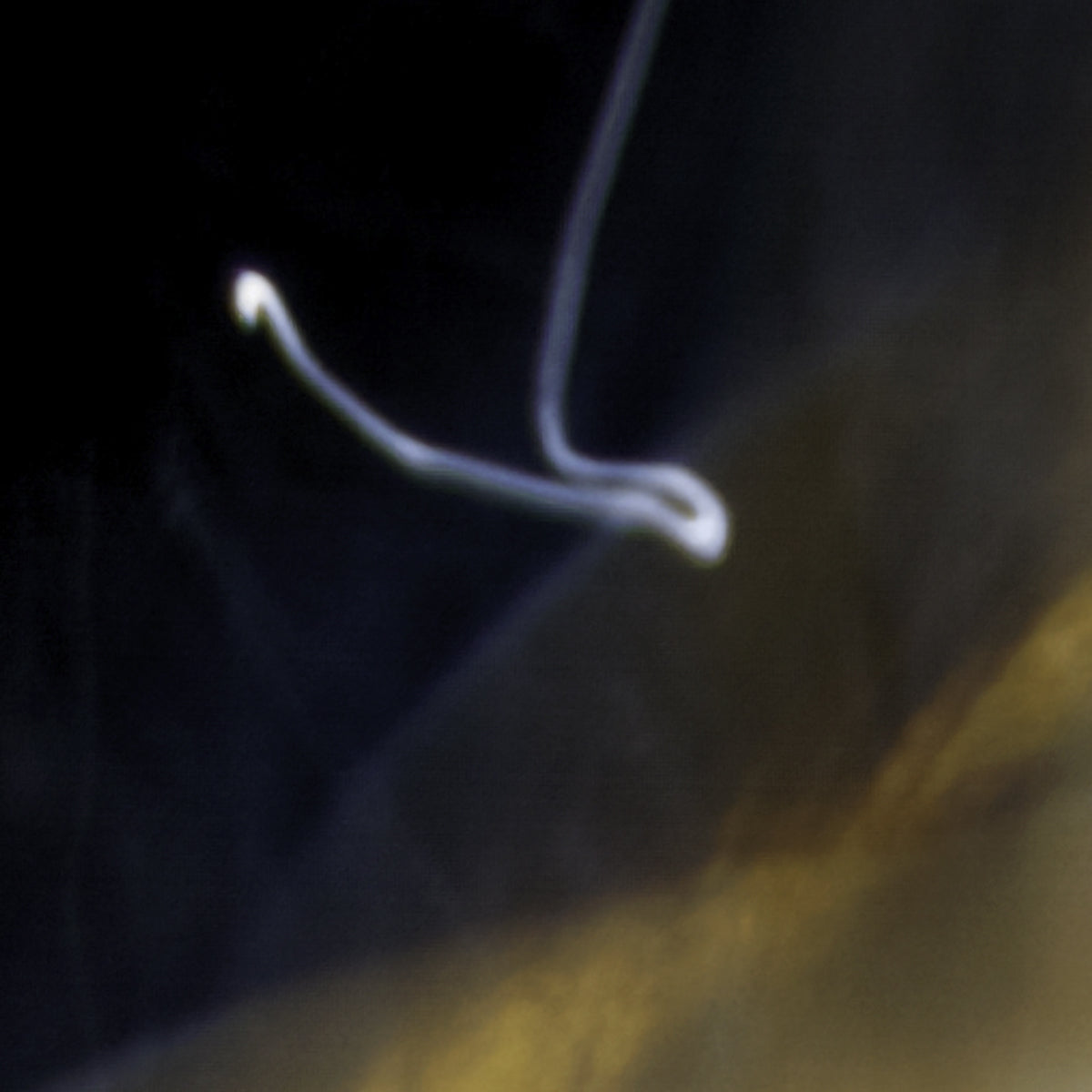 Close-up of a white hook on a dark background