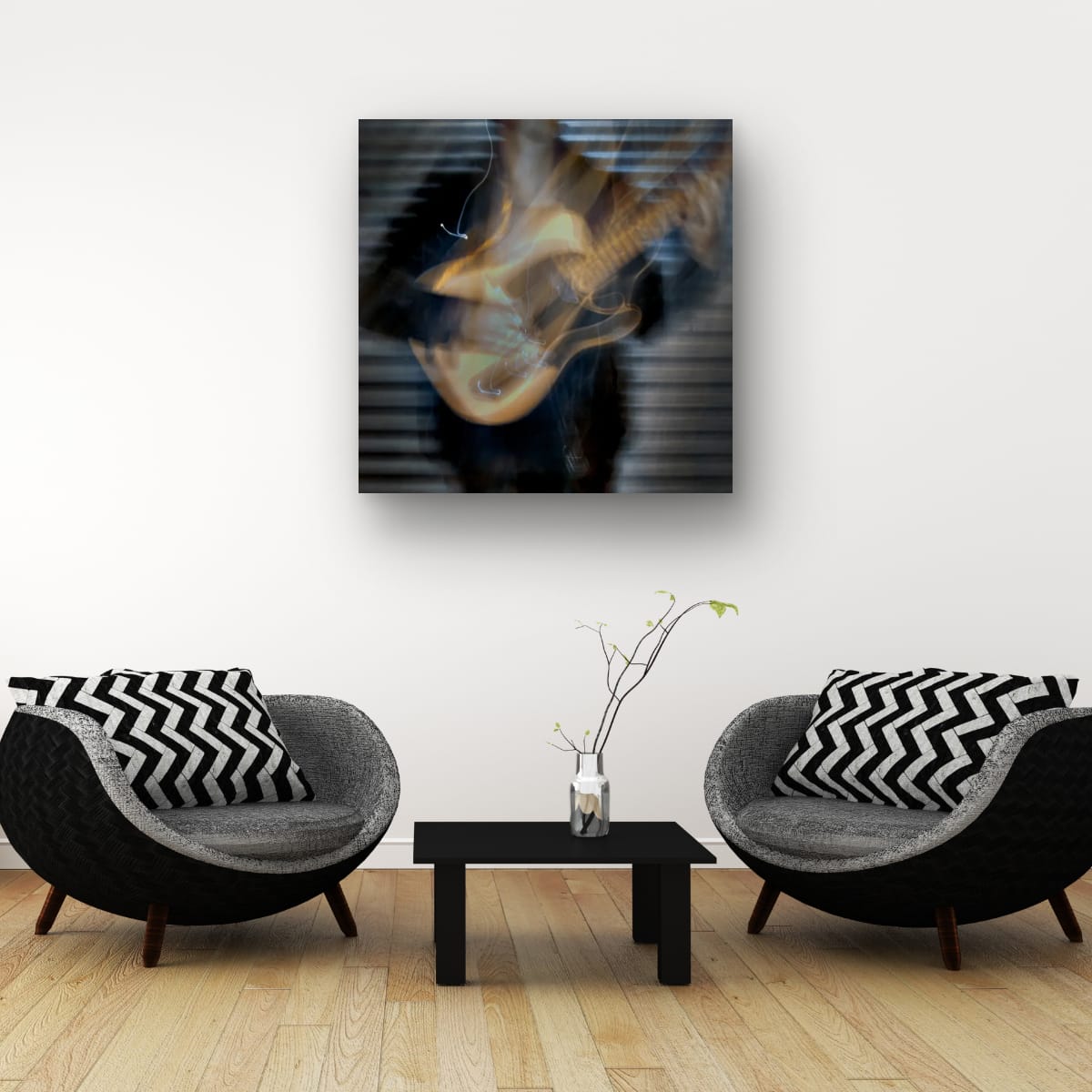 Modern living room with two black and gray chairs, a coffee table, and a guitar painting on the wall.