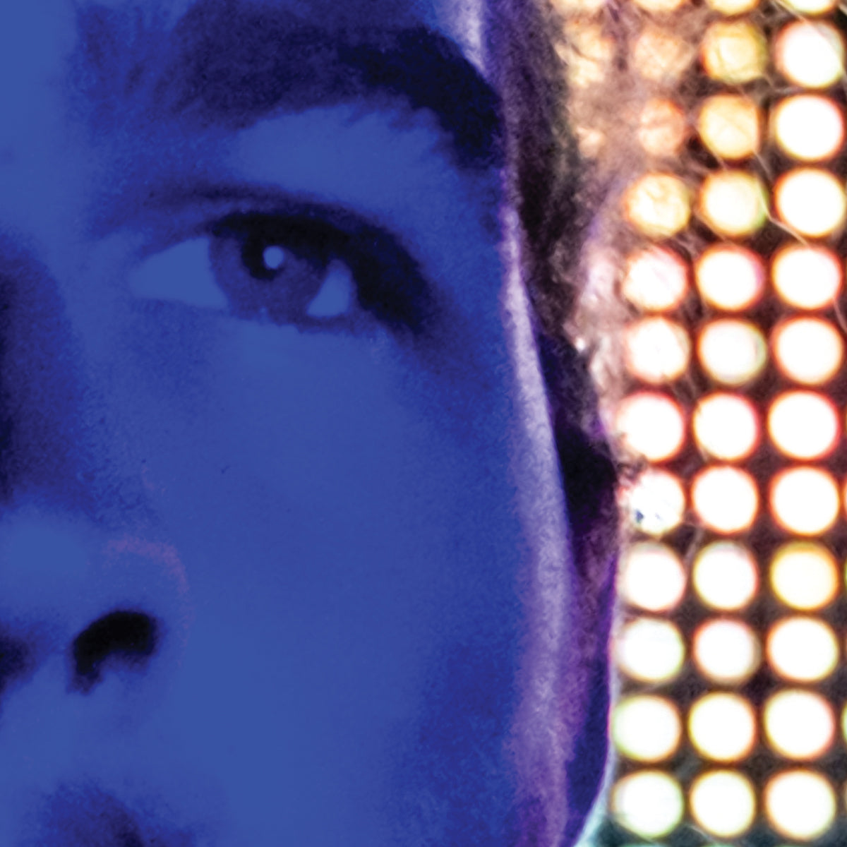 Close-up of a person's eye with colorful lights in the background
