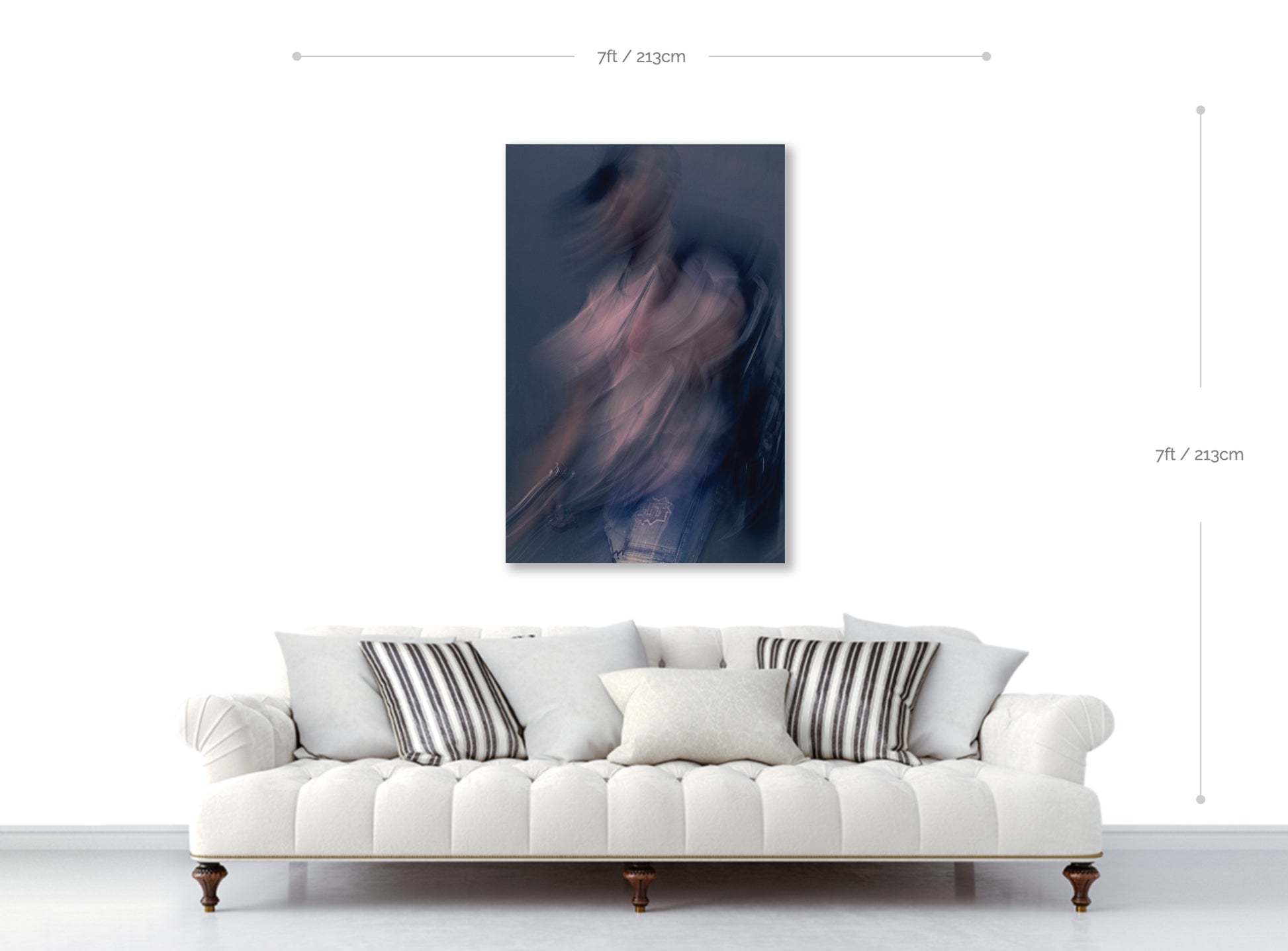 White sofa with decorative pillows and a abstract painting on the wall