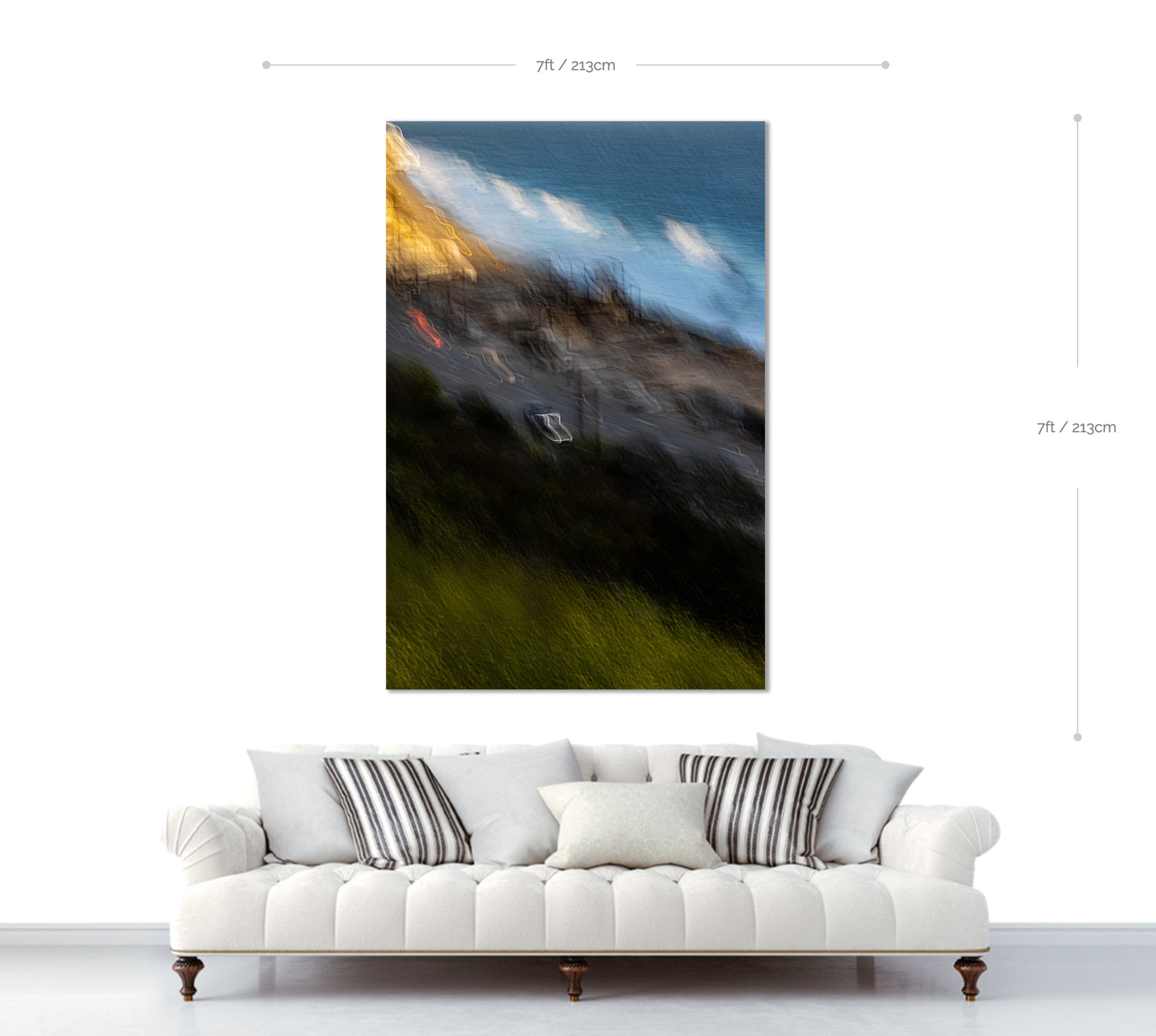 Large abstract painting above a white sofa with decorative pillows.