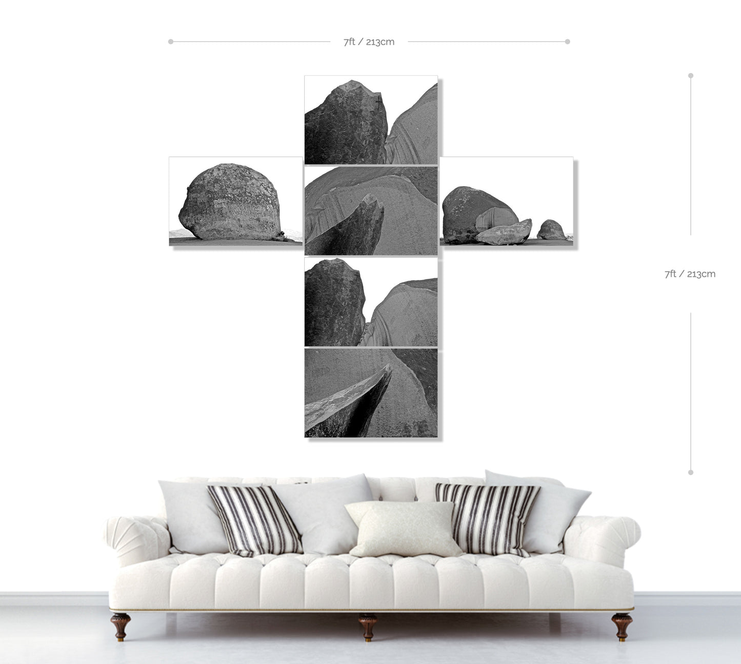 Wall art with black and white abstract designs above a white sofa.