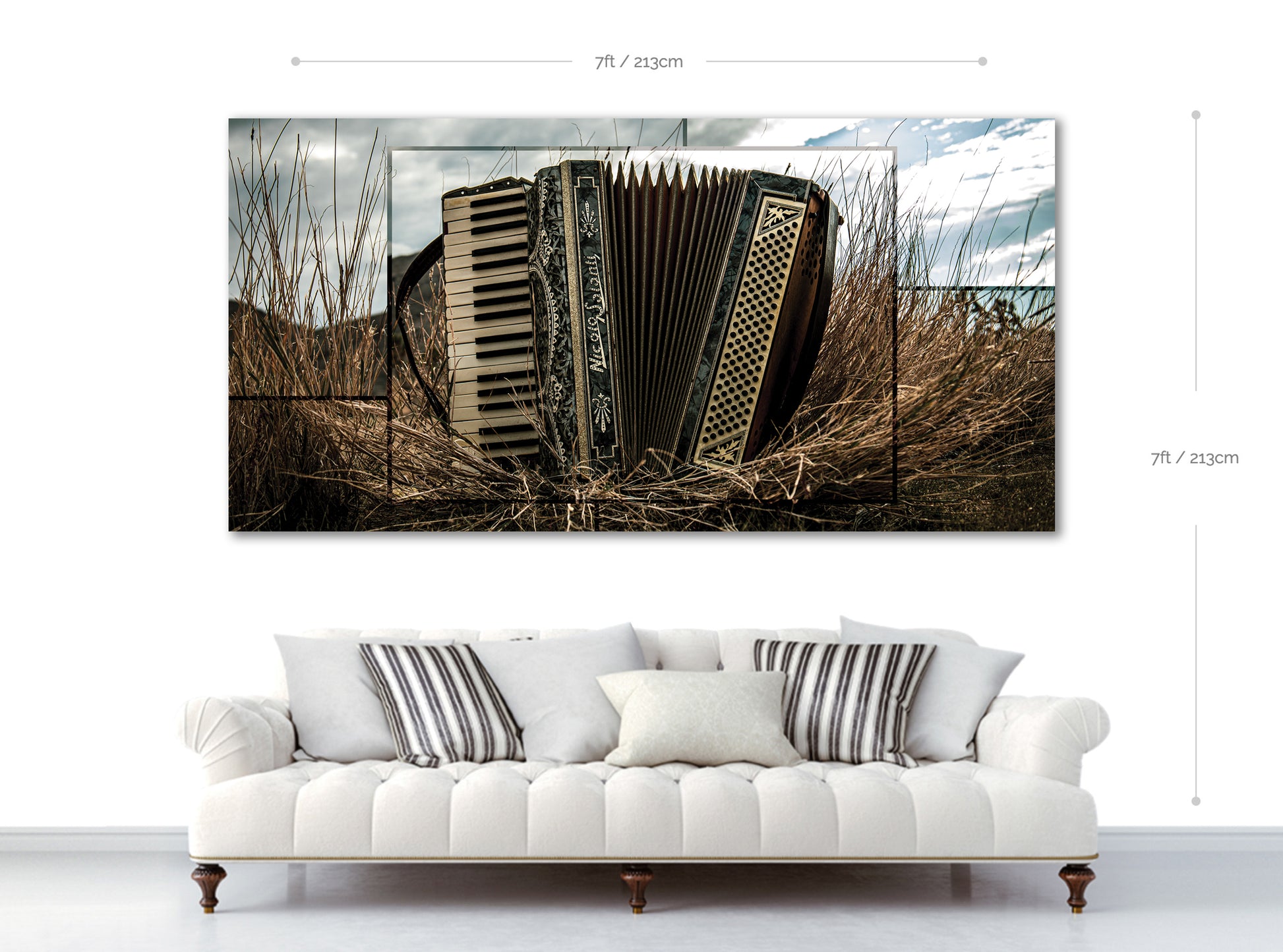 Accordian art print on a wall above a white sofa with decorative pillows.