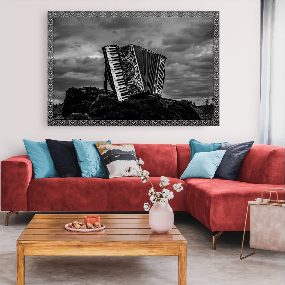 Living room with a red sofa, wooden coffee table, and a large framed picture of an accordion on the wall.