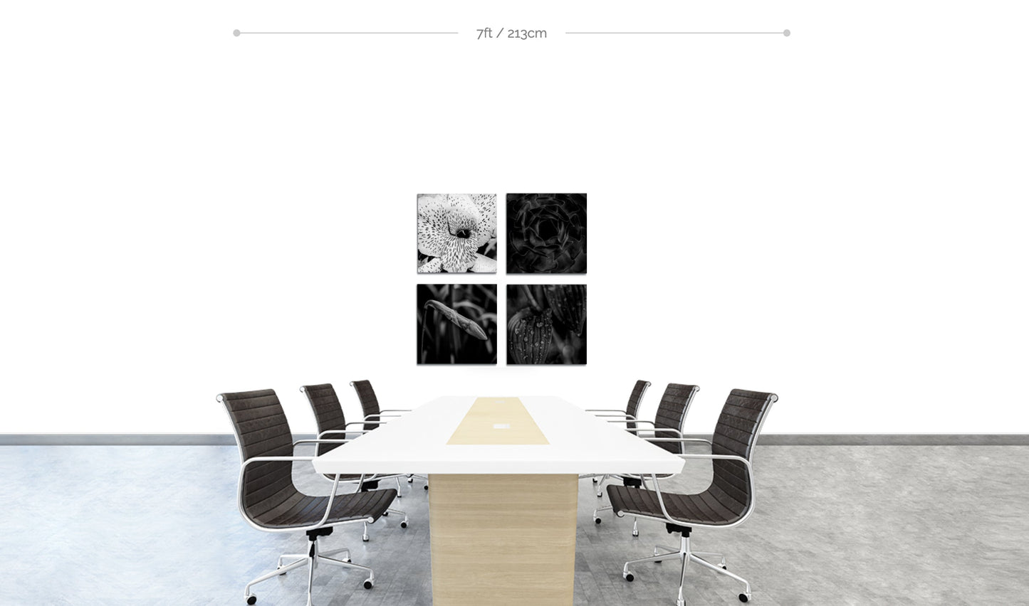 Set of 4 floral prints arranged in square hanging on boardroom wall